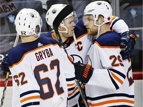 Edmonton Oilers center and captain Connor McDavid center, congratulates Edmonton Oilers centre Leon Draisaitl (29) of Germany who fed him the puck for the winning goal in overtime of an NHL hockey game against the New York Islanders in New York, Tuesday, Nov. 7, 2017. Edmonton Oilers Eric Gryba (62) is at right for the celebration.