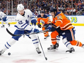 Matt Benning #83 of the Edmonton Oilers defends against Tyler Bozak #42 of the Toronto Maple Leafs at Rogers Place on November 30, 2017  at Rogers Place.