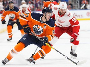Connor McDavid #97 of the Edmonton Oilers is pursued by Frans Nielsen #51 of the Detroit Red Wings at Rogers Place on November 5, 2017 in Edmonton, Canada.