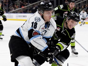 Kootenay Ice forward Vince Loschiavo, left, battles Edmonton Oil Kings defenceman Wyatt McLeod battles  during WHL action on Nov. 24, 2017, at Rogers Place in Edmonton.