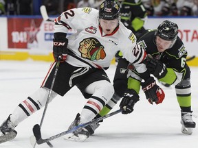 The Edmonton Oil Kings' Wyatt McLeod (6) battles the Portland Winterhawks' Kieffer Bellows (22) during second period WHL action at Rogers Place in Edmonton Saturday Nov. 25, 2017.