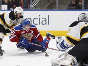 Edmonton's Davis Koch (16) is tripped by Brandon's Schael Higson during the second period of a WHL game between the Edmonton Oil Kings and the Brandon Wheat Kings at Rogers Place on November 29, 2017.