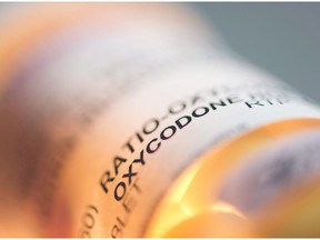 Prescription pill bottle containing oxycodone and acetaminophen are shown in this June 20, 2012 photo.