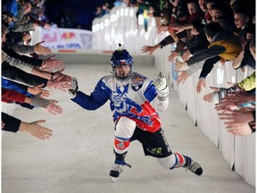 Crushed Ice draws huge crowds in Edmonton. Czech skater Michael Urban (14) high fives the crowd during the Red Bull Crashed Ice Ice Cross Downhill World Championship in Edmonton on Saturday, March 14, 2015.