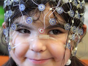 Kaia Anderson-Fillier, 4, wears a cap that measures brain activity while she plays games designed to measure her cognitive abilities as researchers study the relationship between the amount of screen time a child has and their brain development at the University of Alberta on Dec. 2, 2015.