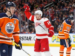 Connor McDavid #97 and Leon Draisaitl #29 of the Edmonton Oilers skate off as Gustav Nyquist #14 of the Detroit Red Wings celebrates a goal at Rogers Place on November 5, 2017 in Edmonton.