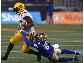 Edmonton Eskimos RB C.J. Gable drags Winnipeg Blue Bombers CB Chris Randle during the CFL West semifinal in Winnipeg on Sun., Nov. 12, 2017.