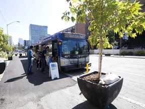 An asphalt pad bus stop along Jasper Avenue, in Edmonton Tuesday Aug. 8, 2017. Bus stops along Jasper Avenue between 109 Street and 115 Street were moved from the curb lane to an asphalt pad along Jasper Avenue as part of the Experience Jasper Avenue Design Demo. The Experience Jasper Avenue Design Demo includes pop-up parks, murals, trees and landscaping in the curb lanes along Jasper Avenue between 109 Street and 115 Street.