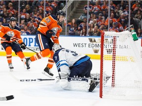 EDMONTON, AB - OCTOBER 09: Ryan Nugent-Hopkins #93 of the Edmonton Oilers scores on goaltender Connor Hellebuyck #37 of the Winnipeg Jets at Rogers Place on October 9, 2017 in Edmonton, Canada.