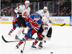 Ty Gerla #39 of the Edmonton Oil Kings battles against Matthew Benson #26 of the Moose Jaw Warriors at Rogers Place on December 7, 2017 in Edmonton, Canada.