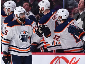 Jujhar Khaira #16 of the Edmonton Oilers celebrates his second period goal with teammates on the bench against the Montreal Canadiens at the Bell Centre on December 9, 2017 in Montreal.