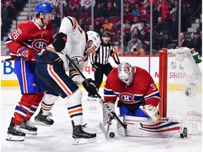Jeff Petry #26 of the Montreal Canadiens tries to defend against Milan Lucic #27 of the Edmonton Oilers while goaltender Antti Niemi #37 makes a save at the Bell Centre on December 9, 2017 in Montreal.