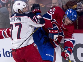 Montreal Canadiens defenceman Brandon Davidson is checked into the boards by Columbus Blue Jackets' Josh Anderson during first period NHL hockey action Tuesday, November 14, 2017 in Montreal.