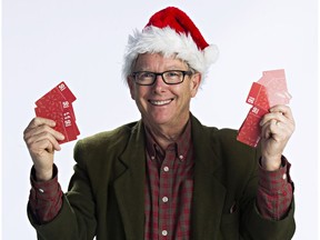 Graham Hicks, founder of Edmonton Sun Adopt-A-Teen, holds up $50 Walmart gift cards ready to be delivered to underprivileged teens. This year, the charity expects to give a gift to 7,800 teens.