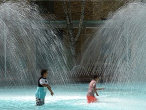 Water will be only ankle deep in the new City Hall fountain design. In this file photo, children play in water past their knees.