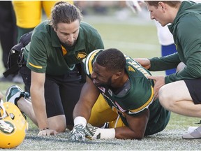 Edmonton Eskimos' John White (30) is injured during first half CFL action against the Montreal Alouettes, in Edmonton on Friday, June 30, 2017.