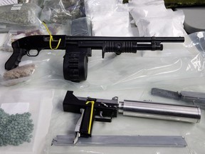 Alberta is waiting to see how much funding it will receive under a federal program to deal with gang-related problems, such as these guns and drugs seized in 2015 by the Edmonton police Drug and Gang Enforcement Unit.