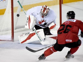 U Sports goalie Carter Hart makes a save on Canada’s Jonah Gadjovich during the third period of their exhibition game last night in St. Catharines, Ont. Canada is in the final stages of selecting its team for the world juniors. (The Canadian Press)