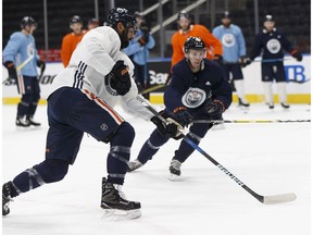 Edmonton Oilers' Jujhar Khaira (16) and Connor McDavid (97) practice with the team at Rogers Place in Edmonton, Alberta on Thursday, December 28, 2017.