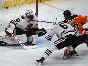 Edmonton Oilers Connor McDavid (97) can't put it past Chicago Blackhawks goalie Jeff Glass during NHL action at Rogers Place in Edmonton, December 29, 2017.