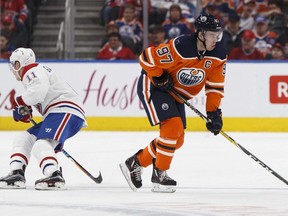 Edmonton's Connor McDavid (97) hobbles off the ice after struck by a puck during the third period between the Edmonton Oilers and the Montreal Canadiens in Edmonton on Saturday, December 23, 2017.