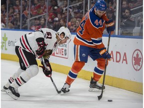 Zack Kassian (44) of the Edmonton Oilers, knocks Brian Campbell of the Chicago Blackhawks off the puck at Rogers Place in Edmonton on Feb. 11, 2017.