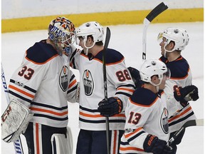 Edmonton Oilers' goalie Cam Talbot (33) and teammate Brandon Davidson (88) celebrate after their 3-2 win against the Minnesota Wild Saturday, Dec. 16, 2017, in St. Paul, Minn.