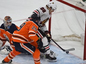 Chicago Blackhawks Patrick Kane get past Edmonton Oilers goalie Cam Talbot (33) and Leon Draisaitl (29) to score in overtime to defeat the Oilers 4-3 during NHL action at Rogers Place in Edmonton, December 29, 2017.