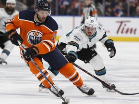 Edmonton's Patrick Maroon (19) battles San Jose's Mikkel Boedker (89) during the second period of a NHL game at Rogers Place between the Edmonton Oilers and the San Jose Sharks in Edmonton, Alberta on Monday, December 18, 2017.