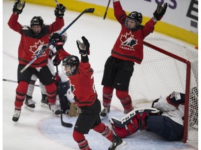 Canada celebrates the game winning goal in overtime by Jennifer Wakefield (9) against the United States during an Olympic tune up exhibition Sunday, Dec. 17, 2017, in Edmonton. (Greg Southam)