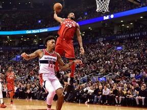 Toronto Raptors forward Norman Powell dunks past Washington Wizards forward Kelly Oubre Jr. on Nov. 5, 2017