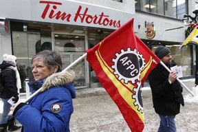 Union workers and supporters gathered to demonstrate in front of Tim Hortons on Sparks Street in Ottawa Wednesday Jan 10, 2018. (Tony Caldwell/Postmedia Network)