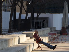 A pedestrian takes a break to soak up the Sun in Churchill Square, in Edmonton Tuesday Dec. 12, 2017. Edmontonians will enjoy another respite from freezing temperatures Jan. 3-4.