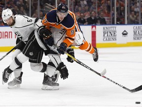 The Edmonton Oilers' Connor McDavid (97) is checked by the Los Angeles Kings' Drew Doughty (8) and Jake Muzzin (6) during first period NHL action at Rogers Place in Edmonton Tuesday, Jan. 2, 2018.