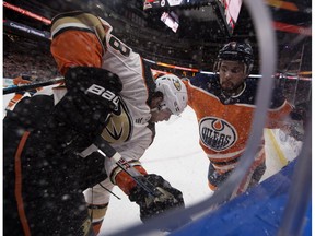 Edmonton Oilers defenceman Kris Russell (4) battles along the boards with the Anaheim Ducks' Derek Grant (38) at Rogers Place in Edmonton on Thursday, Jan. 4, 2018. (David Bloom)