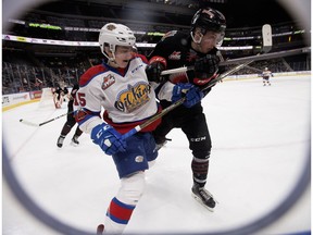 The Edmonton Oil Kings' Scott Atkinson (15) battles the Moose Jaw Warriors' Brayden Burke (19) at Rogers Place on Jan. 6, 2018. The Warriors won 7-2. (David Bloom)