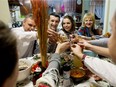 Friends and family enjoy Ukrainian Christmas dinner at Ivan Lypovyk and Bohdana Stepanenko-Lypovyk's home in Edmonton on Sunday, Jan. 7, 2018. Ivan Lypovyk and Stepanenko-Lypovyk came to Edmonton from Ukraine in 2008 and 2013, respectively. They now help newcomers to Canada find employment and friendship.