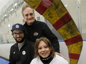 Joseph Gardiner, 10, poses for a photo with his mentors John Putters (top) and Elliott Putters at the Terwillegar Arena, in Edmonton Sunday, Jan. 14, 2018.