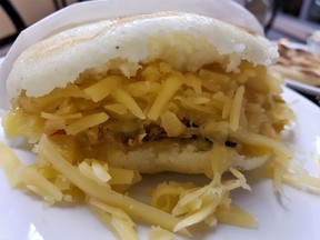 El Fogon Latino’s shredded chicken and melted gouda arepa.