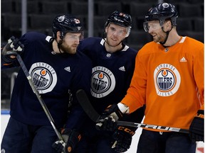 Leon Draisaitl, left, Connor McDavid and Adam Larsson take part in an Edmonton Oilers practice at Rogers Place in Edmonton on Friday, Jan. 19, 2018. (David Bloom)