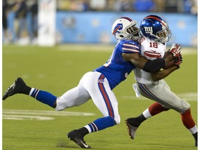 Free safety Kenny Ladler #31 of the Buffalo Bills tackles wide receiver Marcus Harris #18 of the New York Giants at the 2014 NFL Hall of Fame Game at Fawcett Stadium on Aug. 3, 2014, in Canton, Ohio. (File)