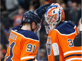 Drake Caggiula #91 and goaltender Cam Talbot #33 of the Edmonton Oilers celebrate their victory against the Vancouver Canucks at Rogers Place on January 20, 2018.