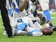 Carolina Panthers quarterback Cam Newton lies on the field after being sacked during an NFL NFC wild-card playoff football game against the New Orleans Saints on Sunday, Jan. 7, 2018 in New Orleans. (Scott Clause/The Daily Advertiser via AP)