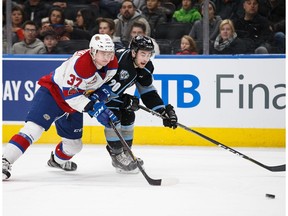 Conner McDonald #37 of the Edmonton Oil Kings battles for possession with Michael King #20 of the Kootenay Ice during Western Hockey League action at Rogers Place in Edmonton on Saturday, Dec. 30, 2017.
