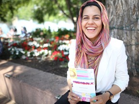 Teacher Sana Ayesha Ghani poses last July with a copy of Traditional X, a book she developed with her Grade 6-7 class in Cadotte Lake.