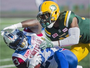 Montreal Alouettes' Brandon Rutley, left, is tackled by Edmonton Eskimos' Kenny Ladler during CFL action in Montreal on Oct. 10, 2016.