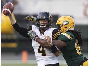 Hamilton Tiger-Cats quarterback Zach Collaros (4) is sacked by Edmonton Eskimos' Marcus Howard (91) during first half CFL action in Edmonton, Alta., on Friday August 4, 2017.