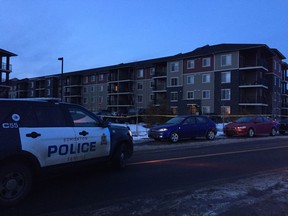 Police investigate what appears to be a shooting in southwest Edmonton at about 5:30 p.m. Sunday, Jan. 21, 2018. The parking lot of an apartment building at 120 Street and 22 Avenue SW was blocked and multiple bullet casings could be seen on the ground behind yellow police tape.