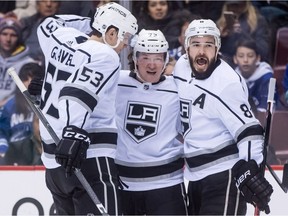 Los Angeles Kings' Kevin Gravel, from left, Tyler Toffoli and Drew Doughty celebrate Toffoli's goal during first period NHL hockey action against the Vancouver Canucks, in Vancouver on Saturday, December 30, 2017.
