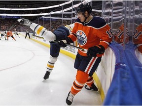 Buffalo Sabres centre Jordan Nolan (17) is checked by Edmonton Oilers centre Ryan Strome (18) in Edmonton on Tuesday, Jan. 23, 2018.